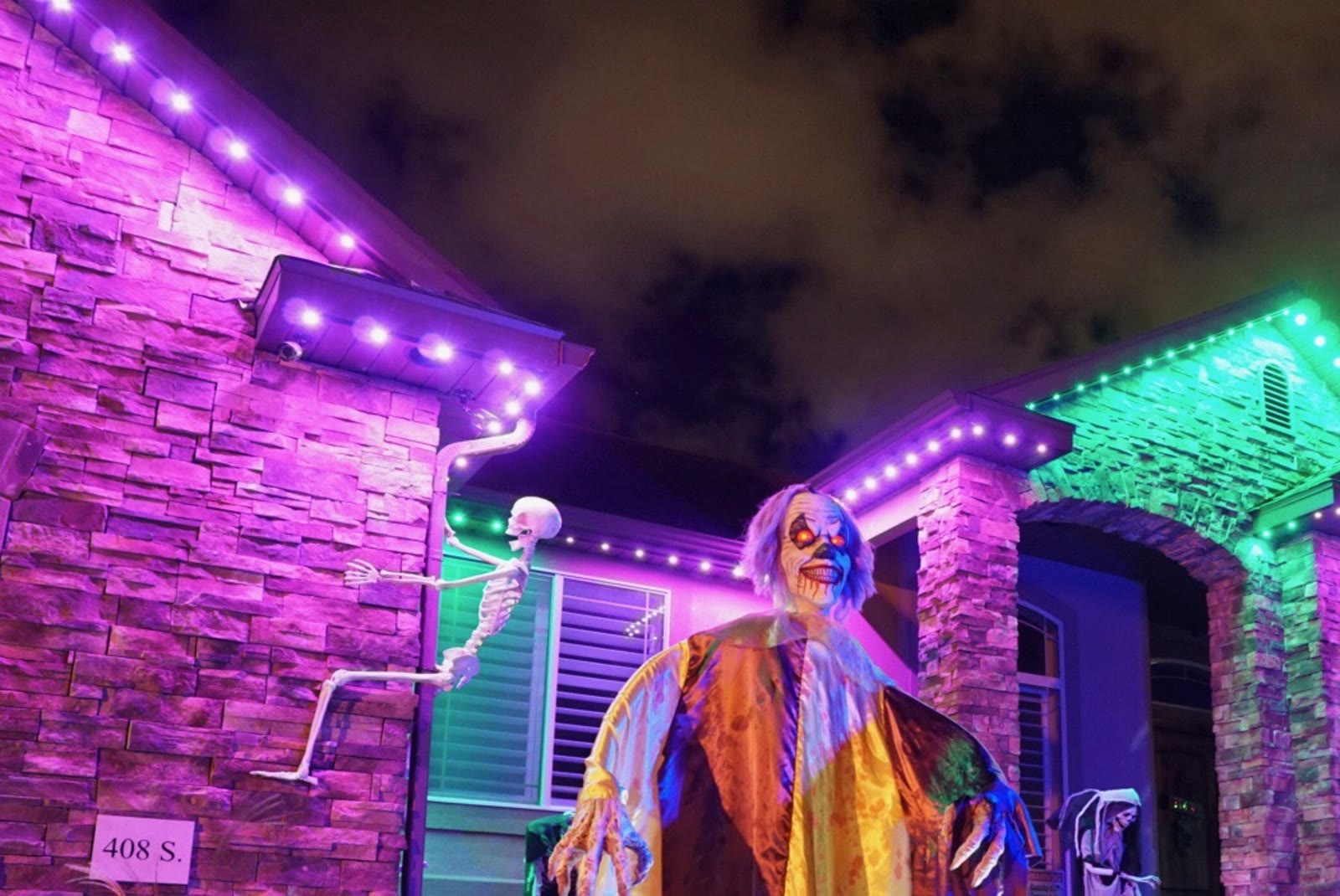 Permanent Christmas lights on home roofline at night