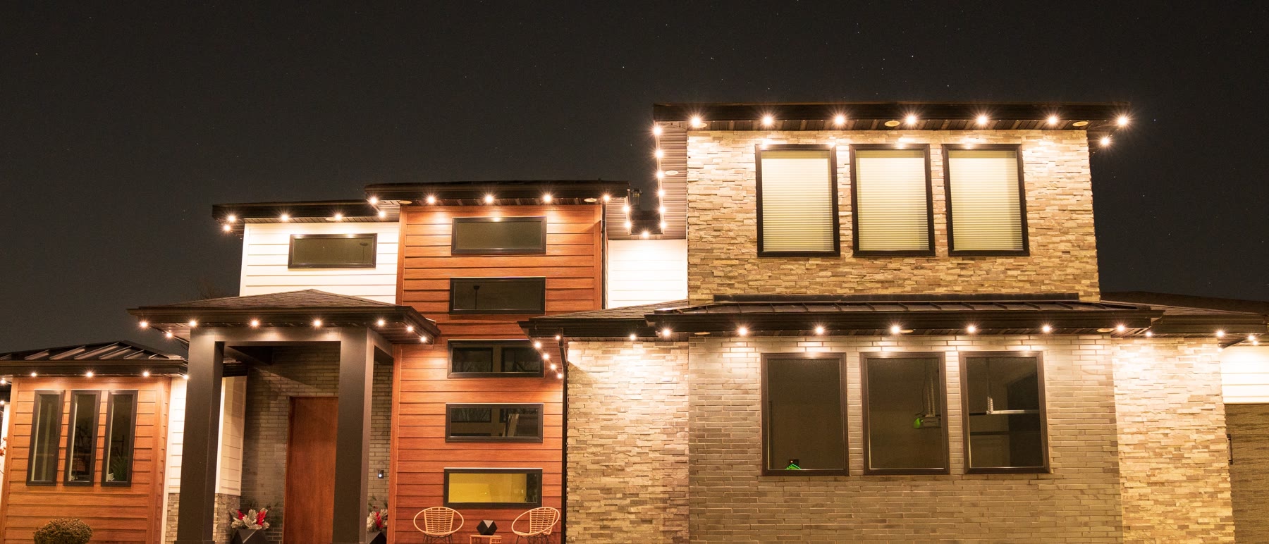 Same Fresno home illuminated at night with permanent outdoor lighting